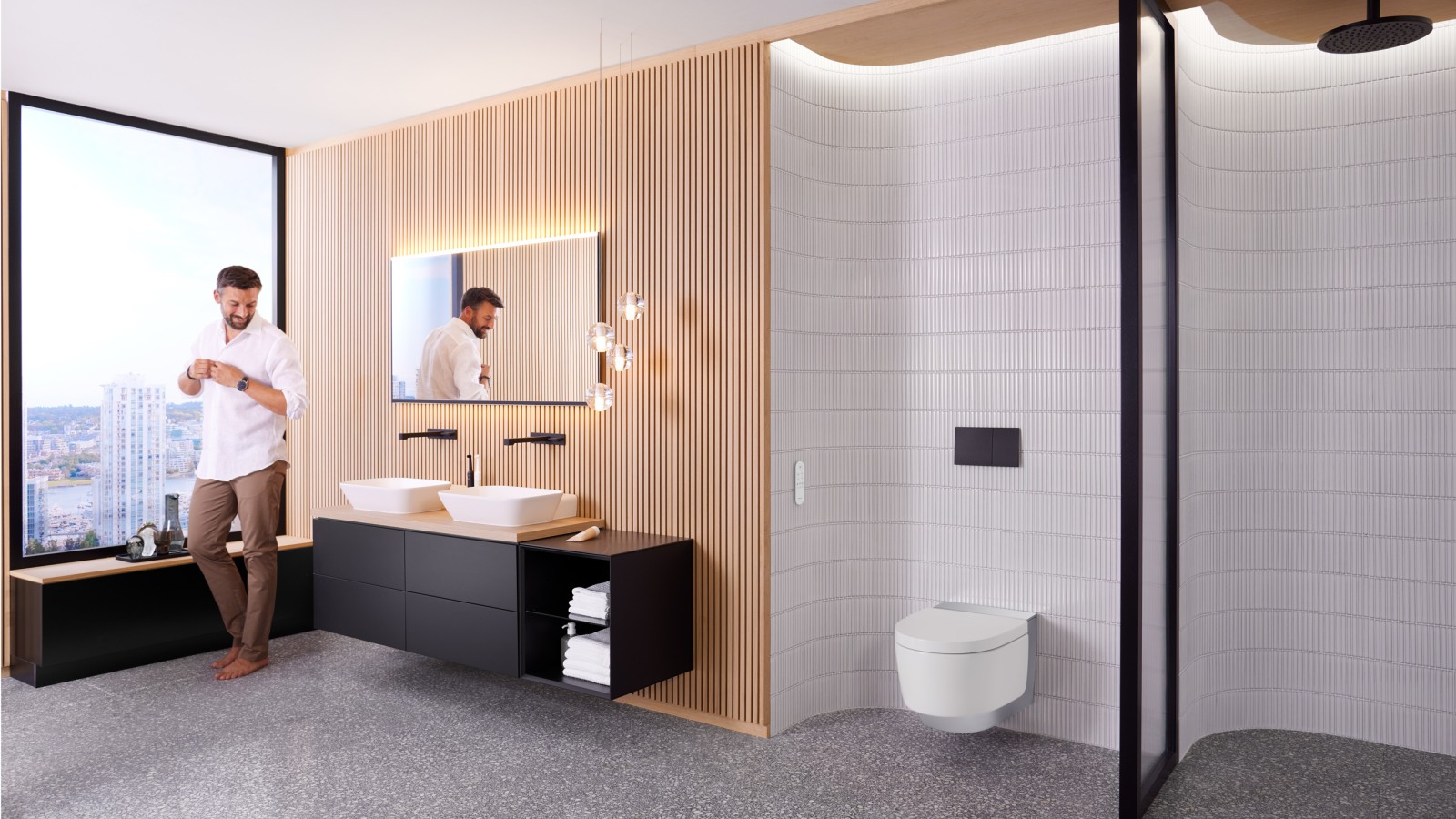 Man in Geberit ONE badkamer met Geberit AquaClean Mera en Geberit Option Plus Spiegel Man in Geberit ONE badkamer met Geberit AquaClean Mera en Geberit Option Plus Spiegel