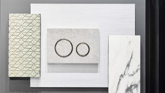 De Geberit Sigma21 bedieningsplaat in betonlook met verchroomde designringen De Geberit Sigma21 bedieningsplaat in betonlook met verchroomde designringen