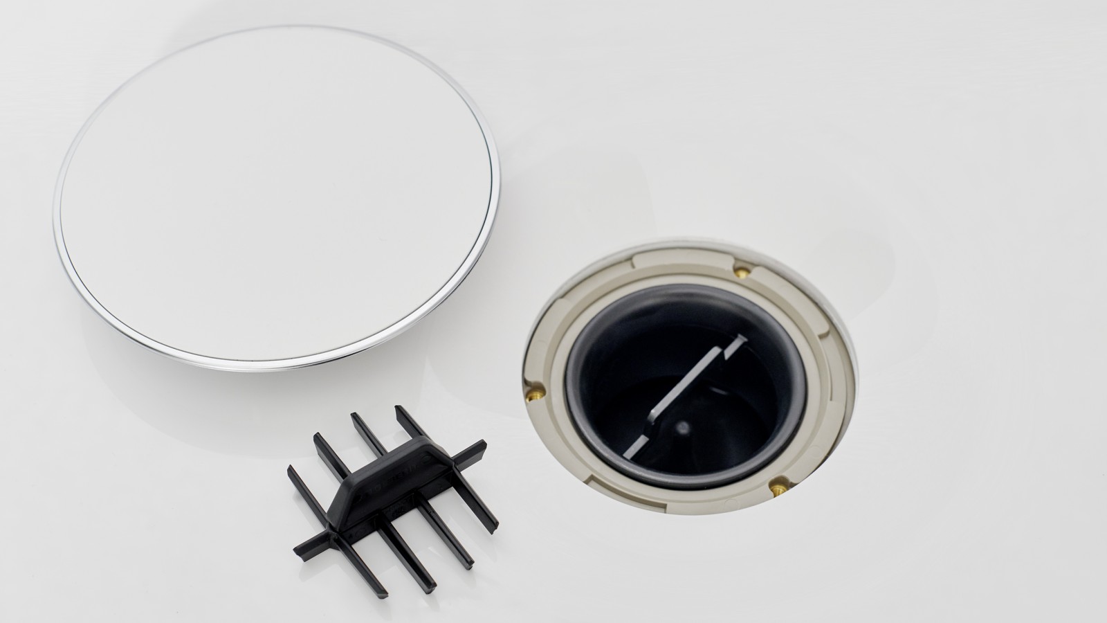 Afvoerkap met kamvormige haarzeef Afvoerkap met kamvormige haarzeef